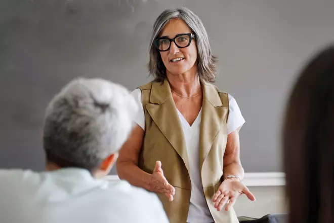 older woman teaching a class