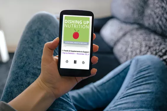 Person holding gphone with the Dishing Up Nutrition logo and a podcast player on the phone