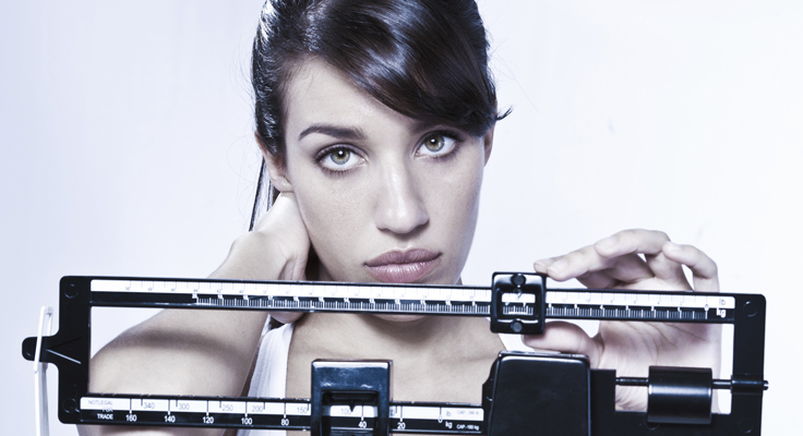 EatingDisorders_SadWomanOnScale.jpg