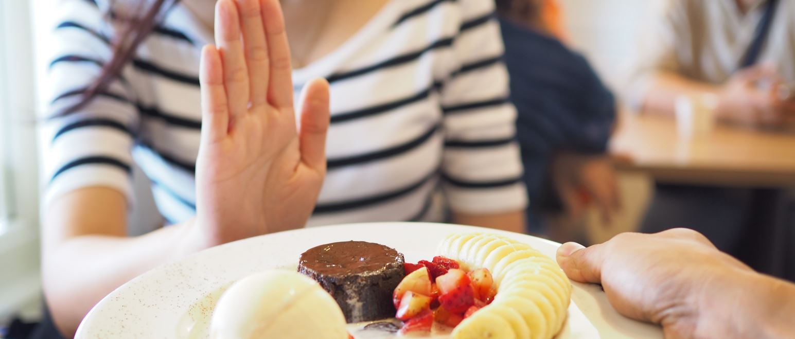 woman saying no to sugar.JPG